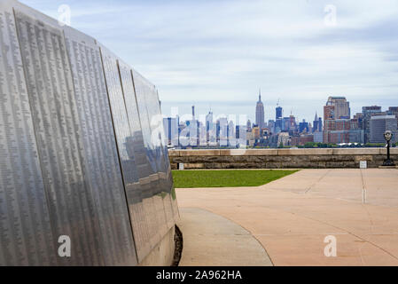 USA, New York, Ellis Island - May 2019: The American Immigrant Wall of Honor is a permanent exhibit of individual or family names featured at Ellis Is Stock Photo