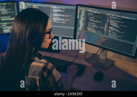 Photo of serious confident focused girl concentrated on hacking the security code of her opponents in spectacles using java script Stock Photo