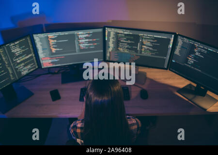 Top above high angle back rear view of focused late concentrated woman debugging her system from failures occurring during work Stock Photo