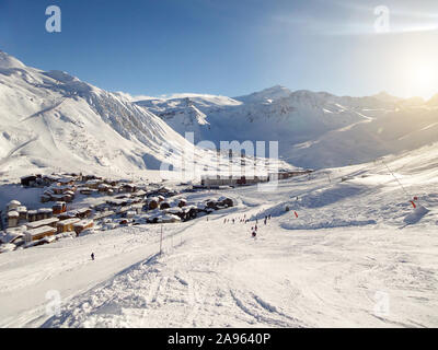 Ski resort of Tignes in winter, ski slope and village of Tignes le lac in the background Stock Photo