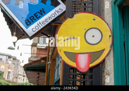 Balat, Turkey - October-16,2019: Sign In Emoji scratched signboard on the street. Stock Photo