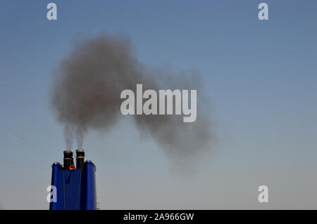 Clouds of Black Smoke Coming from the Funnel of the Luxury P&O Passenger Cruise Ship 'Aurora' as it Sails out of the Harbour in the bay of Gibraltar. Stock Photo