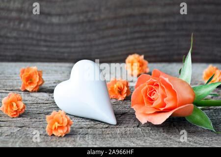 Heart and roses on wooden background Stock Photo
