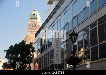 The Clock Tower on the Roman Catholic Cathedral of Saint Mary the Crowned in Main Street next to Marks & Spencer Shop, Gibraltar, Europe, EU. Stock Photo