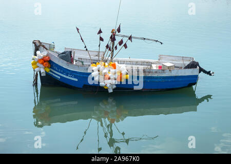 Asilah, Morocco-September 10, 2019: Traditional blue fishing boat in the harbour of Asilah, Morocco Stock Photo