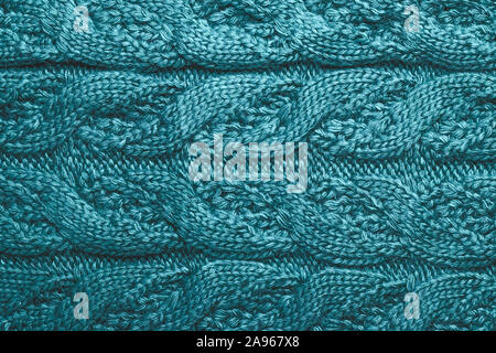 Abstract blue textile background. Loops of wool, yarn with knitting. Ornament on a knitted sweater. Stock Photo