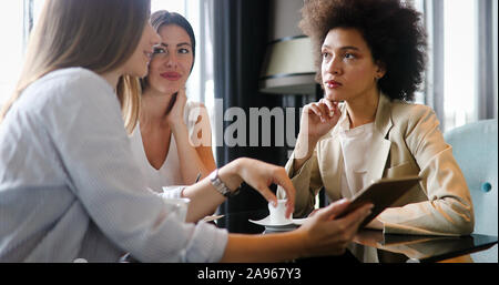 Young happy woman college chatting in a coffee shop Stock Photo