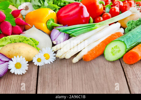 Fresh vegetables harvest against wooden background Stock Photo