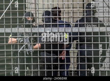 Frankfurt, Germany. 13th Nov 2019. Masked officers of a special police unit bring a man suspected of terrorism to the court for a demonstration. The German of Macedonian origin is said to have planned an attack in the Rhine-Main region together with two others. Photo: Boris Roessler/dpa Credit: dpa picture alliance/Alamy Live News Stock Photo