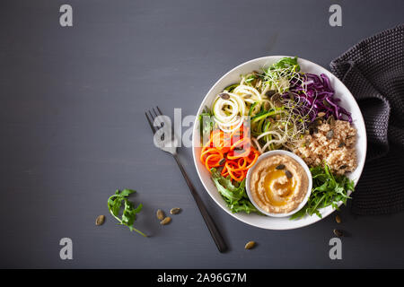 veggie couscous lunch bowl with spiralazed carrots and zucchini, hummus and red cabbage Stock Photo