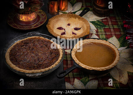 Christmas pecan, cherry and pumpkin pies on a festive Christmas table Stock Photo