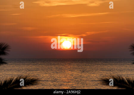cliche shot of red gradient sunset on water Stock Photo