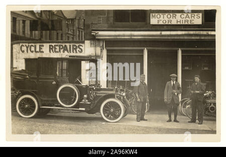 Original early 1900's postcard of cycle repair shop and motor car hire shop, with vintage car outside, circa 1920's, Dundee, Scotland, registration on bike. Stock Photo