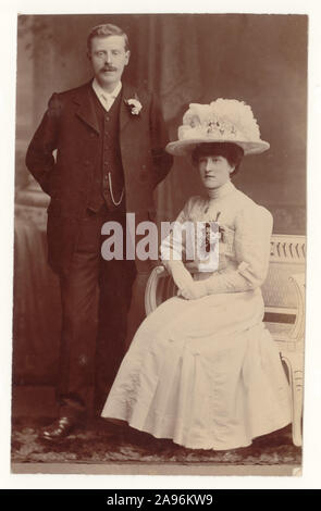 Early 1900's Edwardian English wedding photograph, of married couple, big hair & hat, white dress, corsage.  Edwardian lady. Edwardian woman.Edwardian man. Rochdale, Greater Manchester, England, U.K., circa 1909 Stock Photo