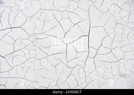 Background texture of cracked compacted marble powder showing an abstract tracery pattern of cracks in a Carrara Mine in Italy Stock Photo