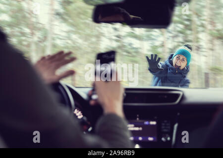 pedestrian accident - man using a phone while driving a car Stock Photo