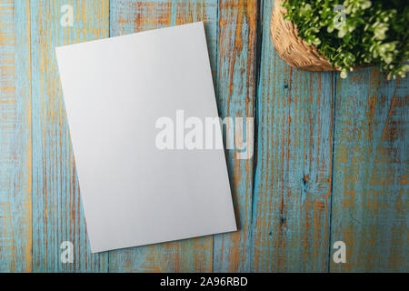 blank A4 brochure mockup on blue wooden background. top view Stock Photo