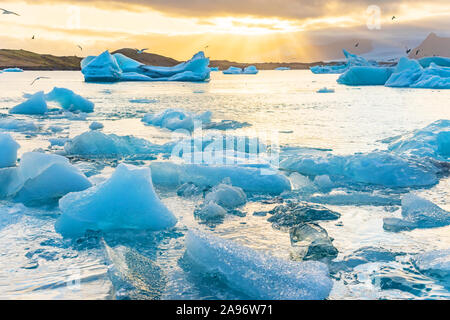 Icebergs floating in Jokulsarlon glacier lagoon lake at sunset. Great tourist attraction in Iceland Gold Circle. Stock Photo