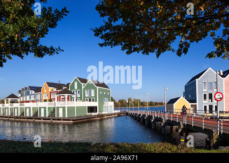 Colorful houses surrounded by water in Houten in the Netherlands Stock Photo