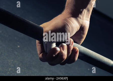 Closeup of man's right hand gripping a barbell with a hook grip Stock Photo  - Alamy