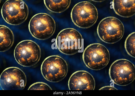 Group of aligned 9 mm bullets for handgun isolated on dark background viewed from directly above. Gun control, crime, military-industrial complex Stock Photo