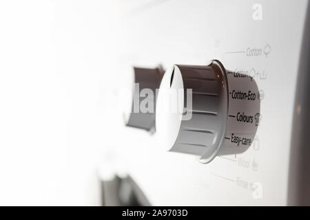 Closeup of white modern washing machine control panel dials and buttons Stock Photo