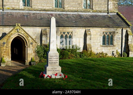 War memorial and St Mary's Church, in the village of Huggate, East Yokshire, England UK Stock Photo
