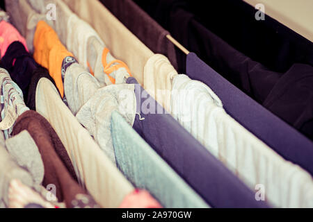 Colourful laundry drying on airer inside the house Stock Photo