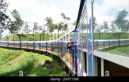 (191113) -- COLOMBO, Nov. 13, 2019 (Xinhua) -- People travel by a Chinese-made train in Sri Lanka, Nov. 1, 2019. Sri Lanka has always been regarded by travel enthusiasts as 'a country with the most beautiful railway network in the world.'   TO GO WITH 'Feature: Chinese-made train makes mountain rail travel in Sri Lanka smoother than ever' (Xinhua/Tang Lu)