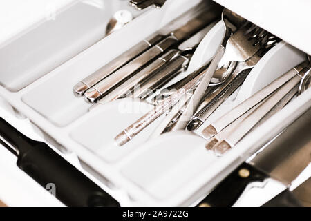 Old messy cutlery drawer in the kitchen Stock Photo