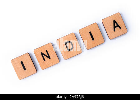 The word INDIA, spelt with wooden letter tiles over a white background. Stock Photo