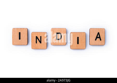 The word INDIA, spelt with wooden letter tiles over a white background. Stock Photo