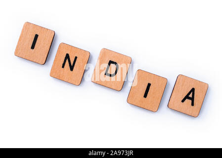 The word INDIA, spelt with wooden letter tiles over a white background. Stock Photo