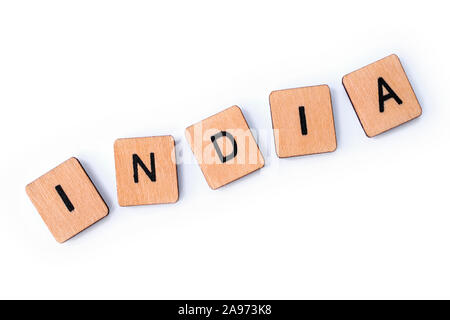 The word INDIA, spelt with wooden letter tiles over a white background. Stock Photo