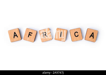 The word AFRICA, spelt with wooden letter tiles, over a plain white background. Stock Photo