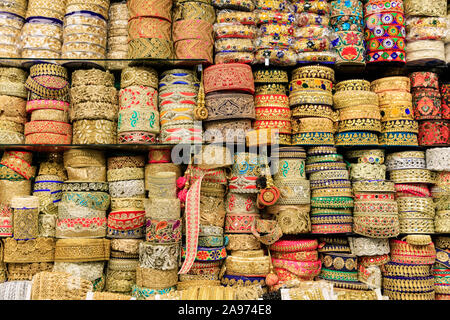 Asian and Indian clothing trims and dress borders in gold and brocade with colourful stitching detail on display Stock Photo