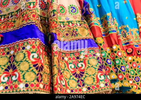 Afghani traditional dresses,detail shot of stitching and embroidery on colourful Afghan Asian clothing in shop display Stock Photo
