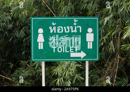 toilet sign written in thai, english and chinese in chiang rai province, northern thailand Stock Photo