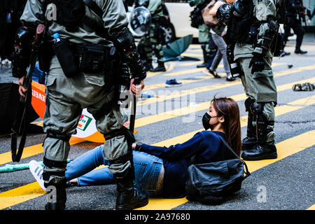 Hong Kong, China. 13th Nov, 2019. Riot police arrest protesters during a protest in the Central district Hong Kong. A ''Blossom Everywhere'' action was organized by the protestors to paralyze traffic and vandalize things across Hong Kong and in its third consecutive days and have sparked some of the worst violence in five months of unrest. Credit: Keith Tsuji/ZUMA Wire/Alamy Live News Stock Photo