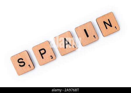 London, UK - July 8th 2019: The word SPAIN, spelt with wooden letter tiles, over a white background. Stock Photo