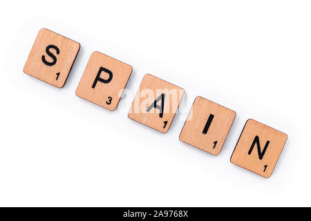 London, UK - July 8th 2019: The word SPAIN, spelt with wooden letter tiles, over a white background. Stock Photo