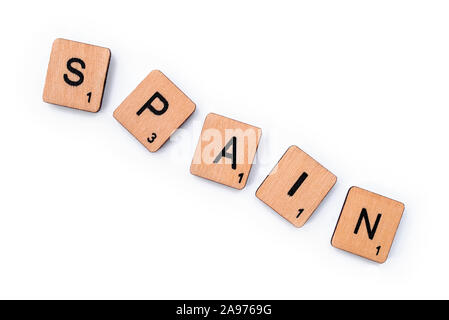 London, UK - July 8th 2019: The word SPAIN, spelt with wooden letter tiles, over a white background. Stock Photo