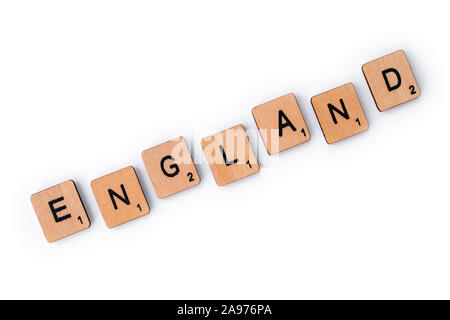 London, UK - July 8th 2019: The word ENGLAND, spelt with wooden letter tiles, over a plain white background. Stock Photo