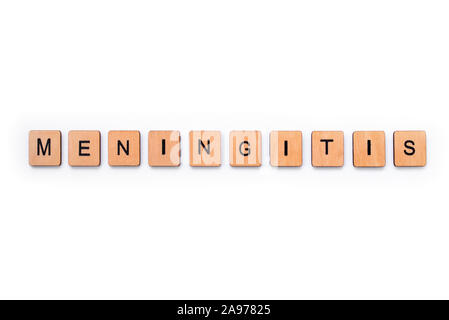 The word MENINGITIS, spelt with wooden letter tiles over a white background. Meningitis is an infection of the protective membranes that surround the Stock Photo