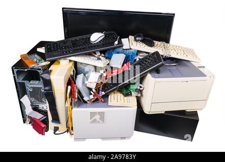 Pile of old computer parts isolated on white background. Used hardware components as keyboards, printers or PC cases. Electronic, metal, plastic waste. Stock Photo