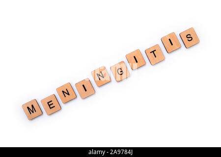 The word MENINGITIS, spelt with wooden letter tiles over a white background. Meningitis is an infection of the protective membranes that surround the Stock Photo