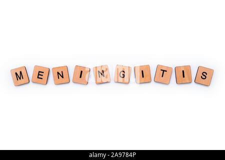 The word MENINGITIS, spelt with wooden letter tiles over a white background. Meningitis is an infection of the protective membranes that surround the Stock Photo