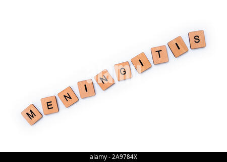 The word MENINGITIS, spelt with wooden letter tiles over a white background. Meningitis is an infection of the protective membranes that surround the Stock Photo