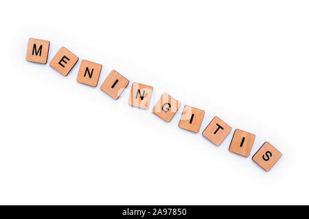 The word MENINGITIS, spelt with wooden letter tiles over a white background. Meningitis is an infection of the protective membranes that surround the Stock Photo