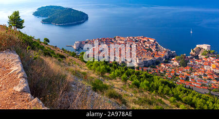 Aerial panoramic view of Lokrum island and Old Town of Dubrovnik with City wall, towers, forts and Old Harbour in Dubrovnik, Croatia